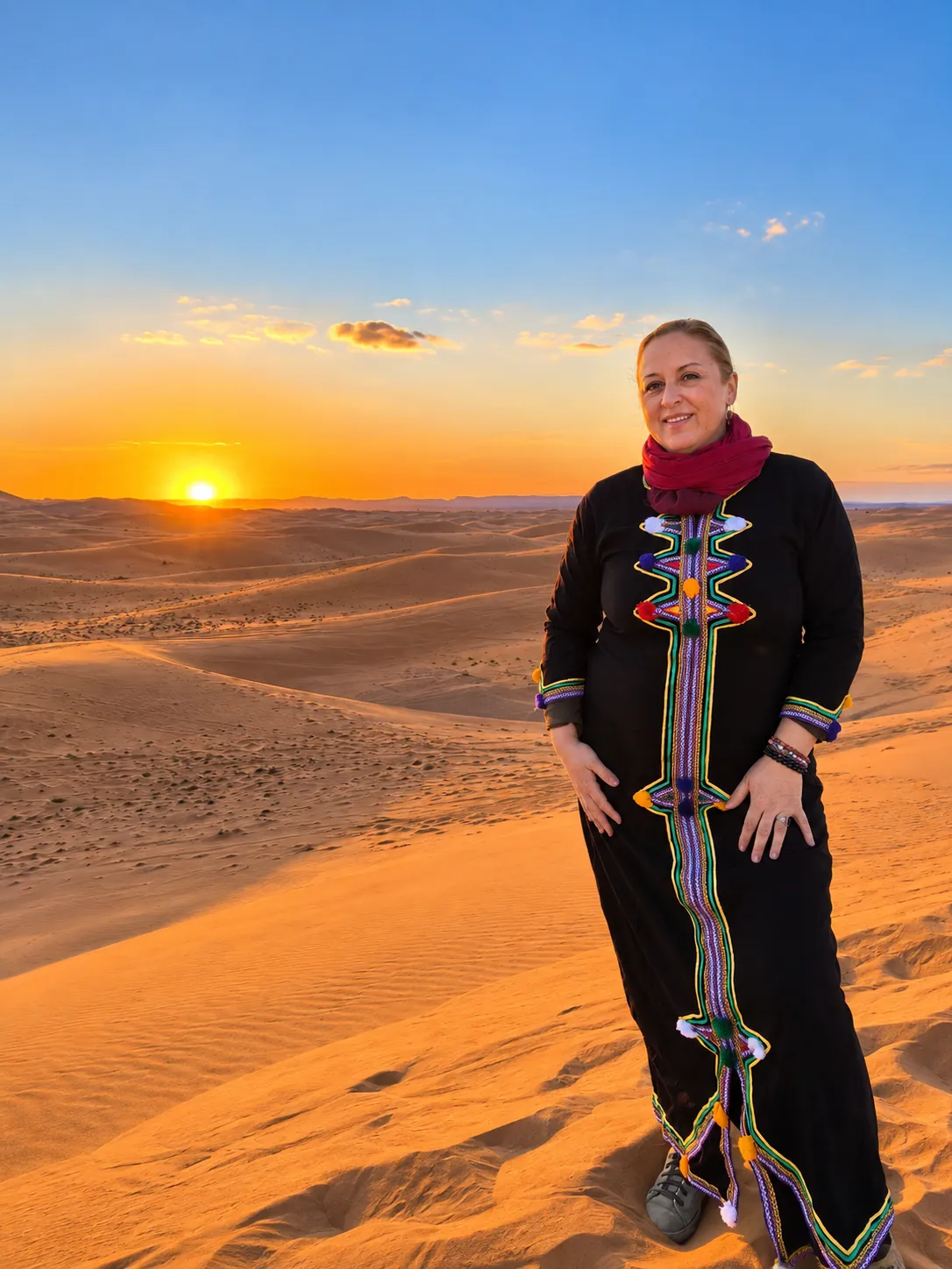 Elsa de pie sobre una duna al atardecer
